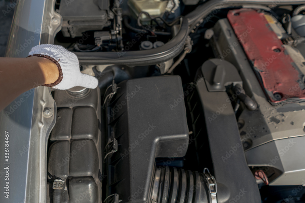 Mechanic or car owner close or open radiator expansion or coolant