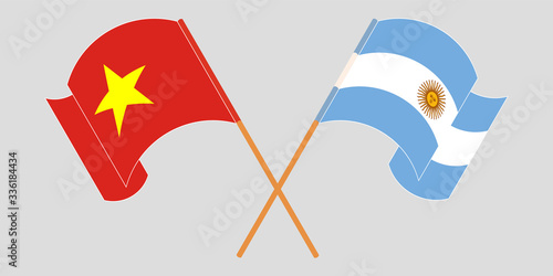 Crossed and waving flags of Argentina and Vietnam