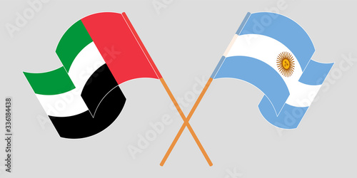 Crossed and waving flags of Argentina and the United Arab Emirates