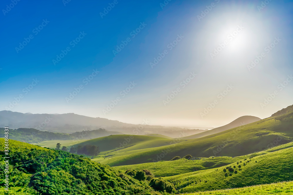 Midday Sun with rolling Green Hills