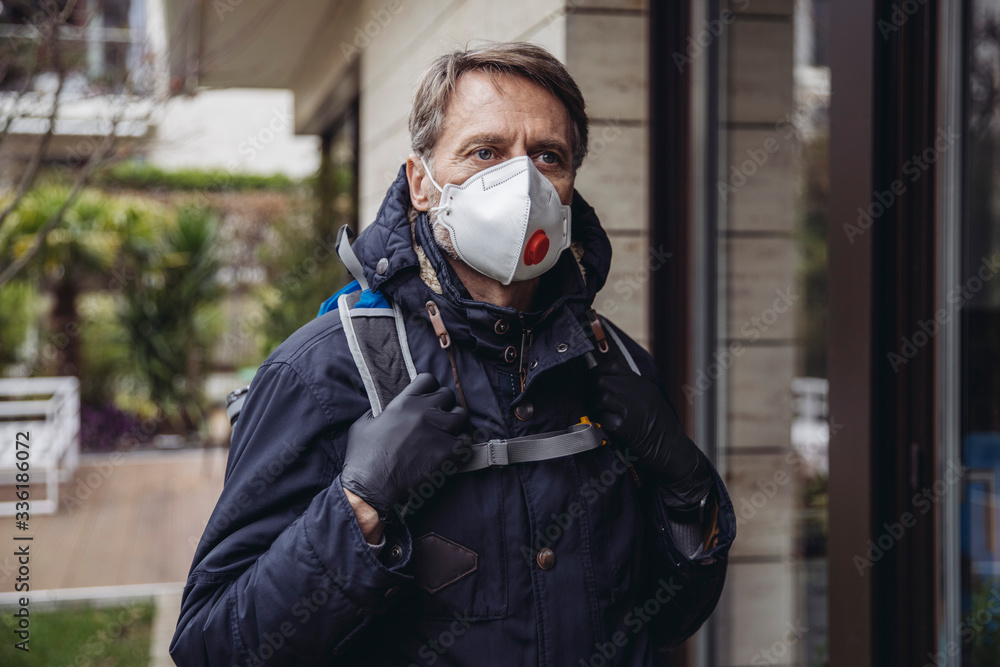 Matuer man commuting in the city, wearing protective mask Matuer man commuting in the city, wearing protective mask
