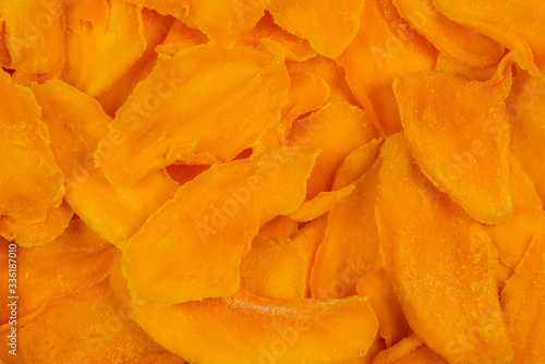 Tasty sugar mango slices background. Top view.