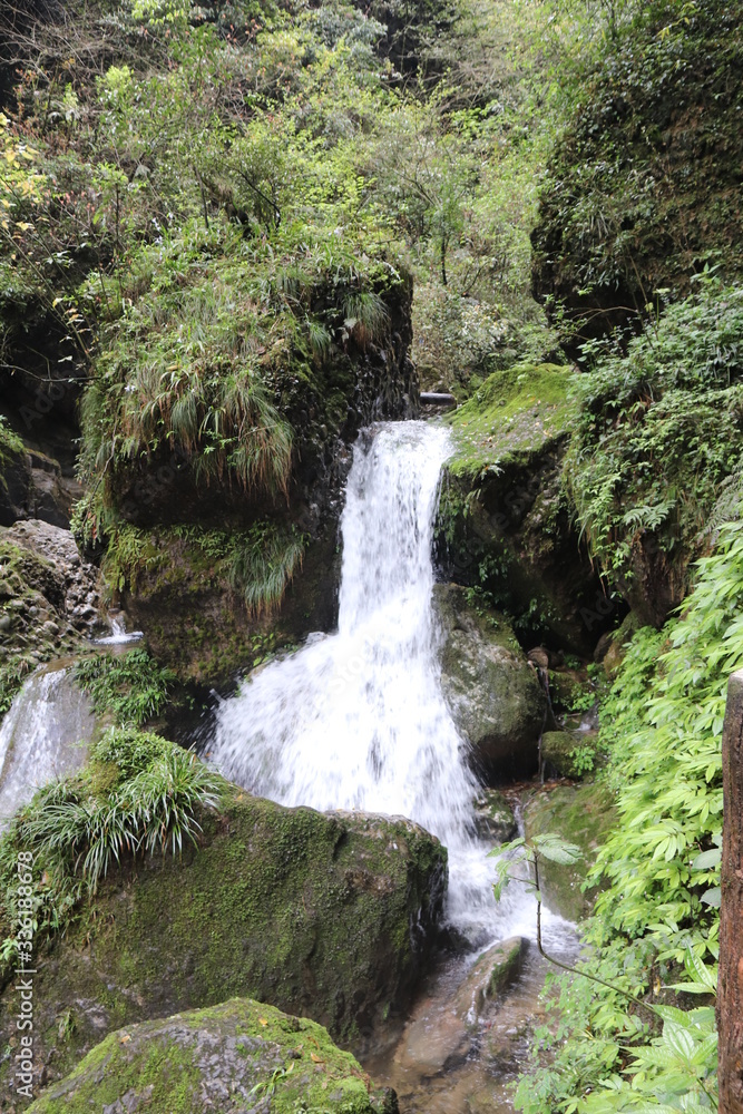 Beautiful landscape of a waterfall in a forest in a Mountain in Sichuan, China Beautiful landscape of a waterfall in a forest in a Mountain in Sichuan, China