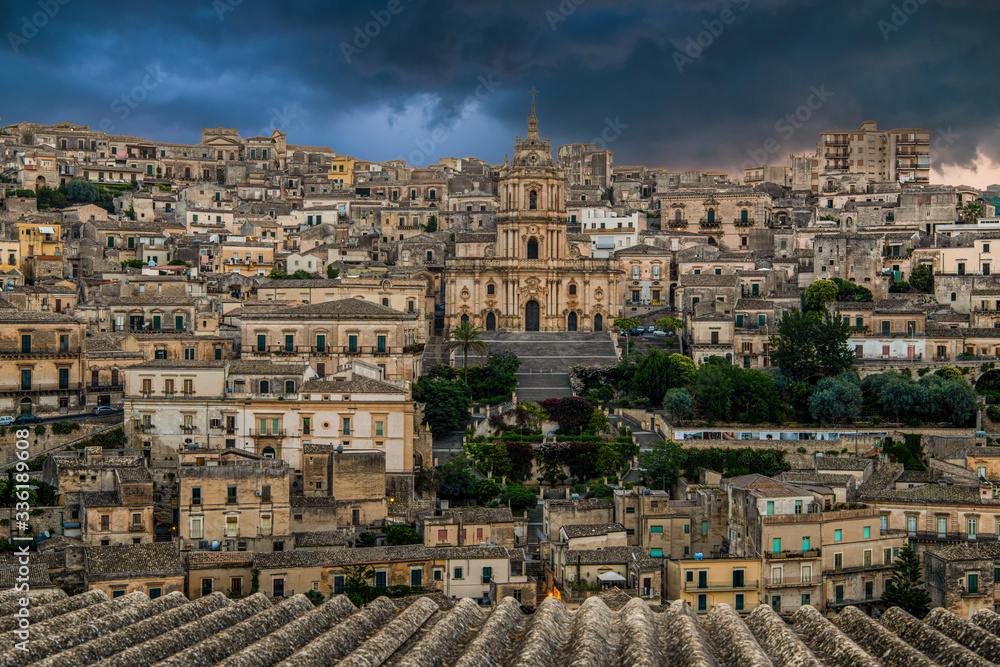 Panoramic view of sicilian baroque town Modica and example of sicilian baroque, Cathedral of Saint George (Duomo of San Giorgio) with the cloudy sky, province of Ragusa, Sicily