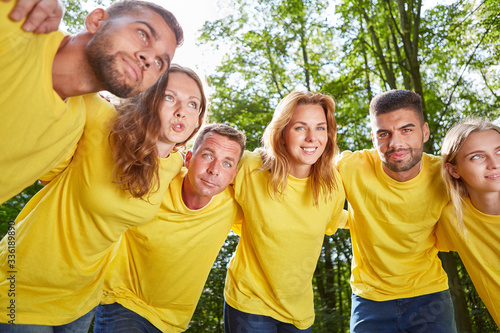 Group of young people hugs each other in the workshop