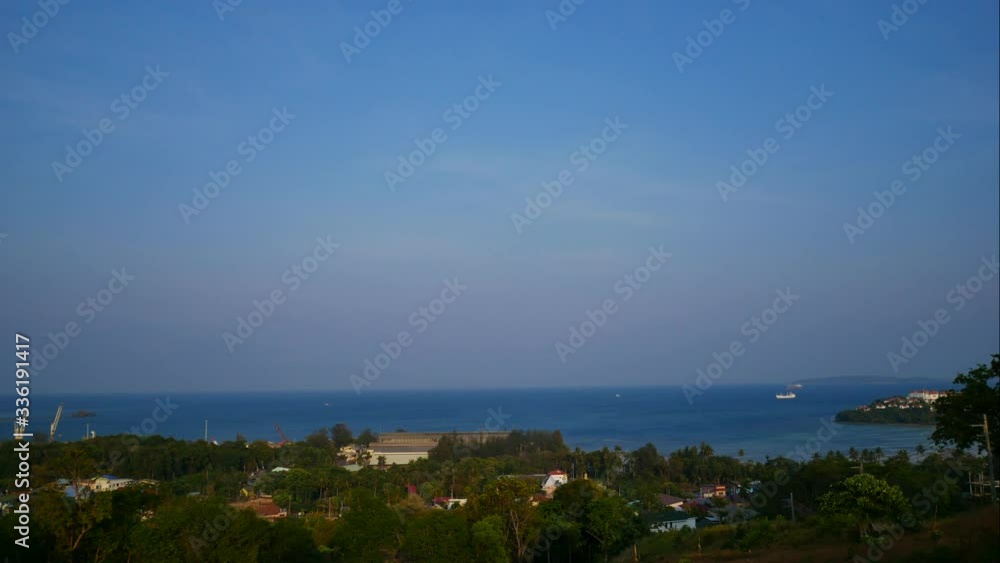 moving leaves tree, soft wave sea water breaking, sailing boat in middle of ocean, Horizon skyline and island are long distance with beautiful blue sky background moving leaves tree, soft wave sea water breaking, sailing boat in middle of ocean, Horizon skyline and island are long distance with beautiful blue sky background