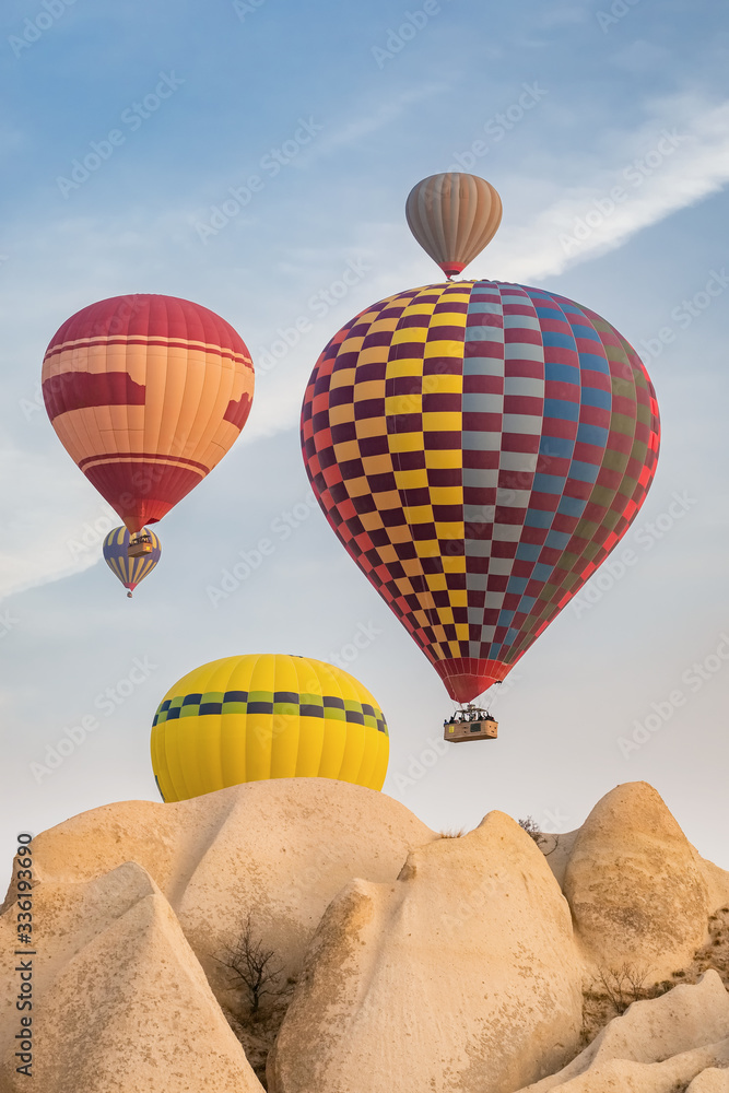 Φωτογραφία Hot air balloons flying over the famous landscape of Cappadocia, Turkey