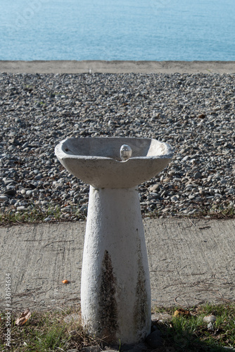 An old fountain with drinking water on the beach is not working. Closed season, pandemic, covid-19 coronavirus. Concept.