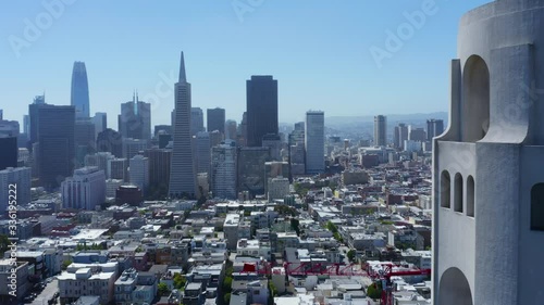 4k aerial drone footage flying past Coit Tower with view of San Francisco Skyline
