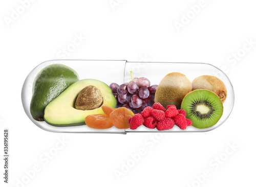 Fototapeta Naklejka Na Ścianę i Meble -  Transparent capsule with different fruits and berries rich in vitamins on white background
