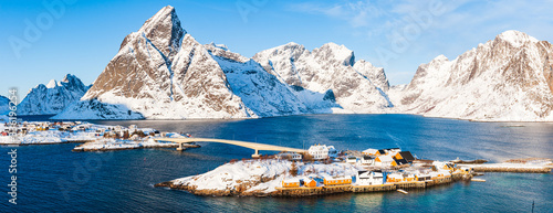 Bridge to island in front of snow covered mountains, Norway, 