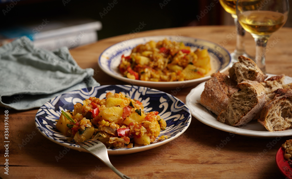 Delicious dinner for two, a wonderful stew of potatoes, peppers, cauliflower, carrots, onions and green parsley. Bread. And white wine.
