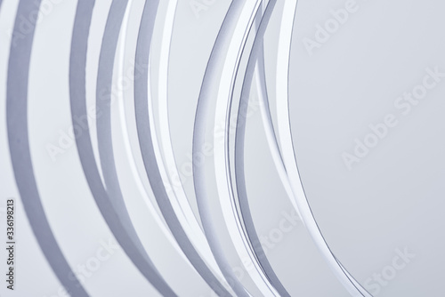 close up view of curved paper stripes isolated on white