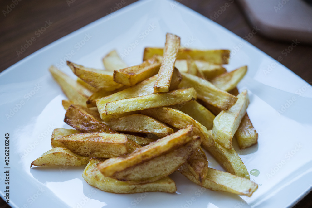 Picture of golden fries on a white plate