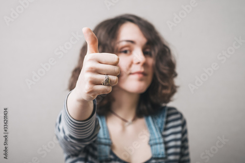 Wallpaper Mural Woman showing thumbs up. On a gray background. Torontodigital.ca