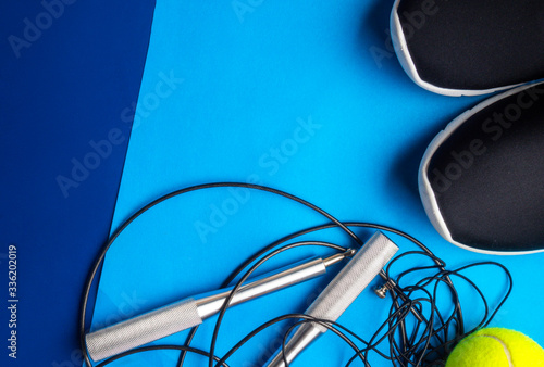 Sport equipment, sneakers on blue background