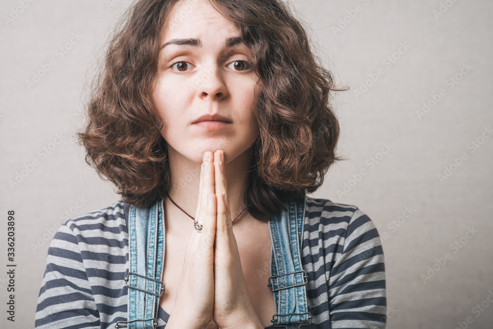 Closeup portrait of a young woman praying Closeup portrait of a young woman praying