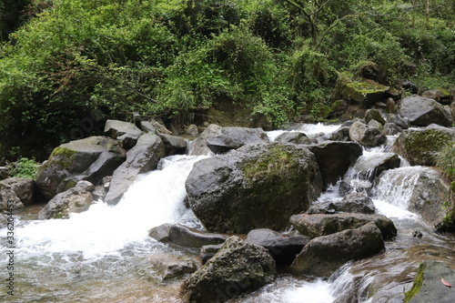 Obraz na płótnie Beautiful landscape of cascade falls over mossy rocks, stones cover with moss, in a Mountain in Sichuan, China w salonie
