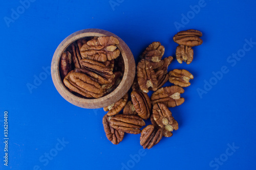 Pekan nut close-up on a classic blue background. photo