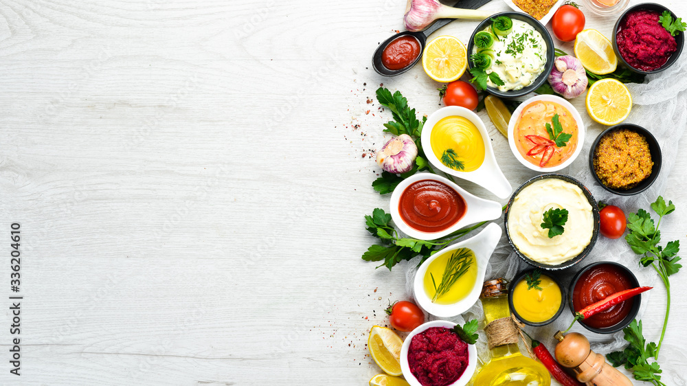 Colored sauces in bowls on a white background. Top view. Colored sauces in bowls on a white background. Top view.