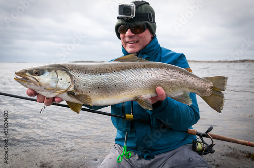 Angler with big colored sea trout