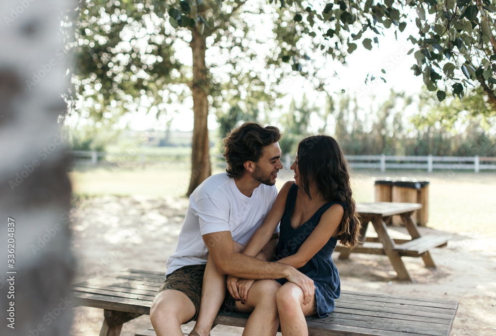 Yong couple kissing in the park. Yong couple kissing in the park.