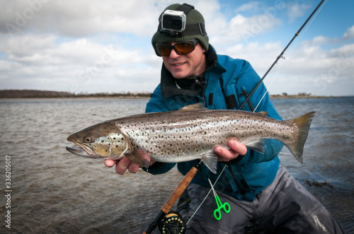 Happy angler with april sea trout