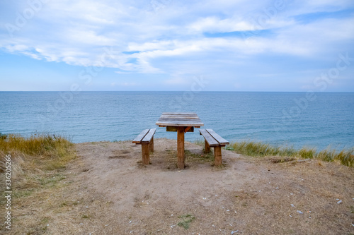 table and benches by the sea. A place to sit and relax.