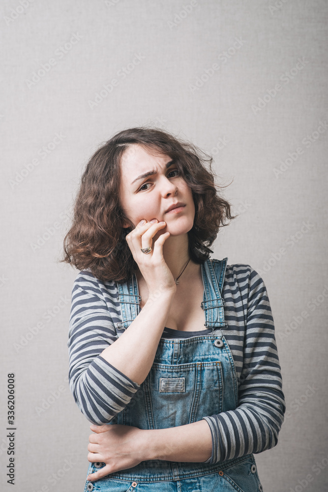 girl has a toothache and she keeps a hand on her cheek girl has a toothache and she keeps a hand on her cheek
