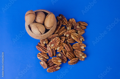 Pekan nut close-up on a classic blue background. photo