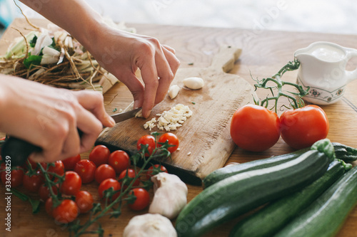 Woman preparing lunch on a wooden kitchen table photo