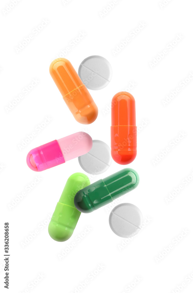 Different falling pills on white background Different falling pills on white background
