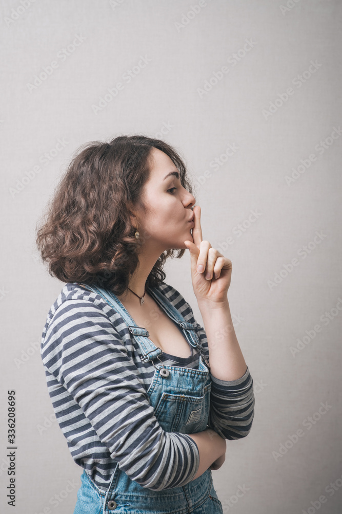 Beautiful woman with secret finger over lips. Beautiful woman with secret finger over lips.