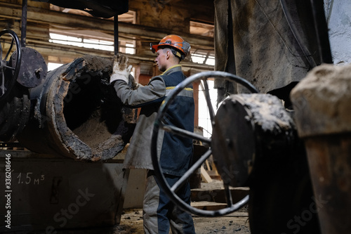 Foundry worker strengthen crucible with clay photo