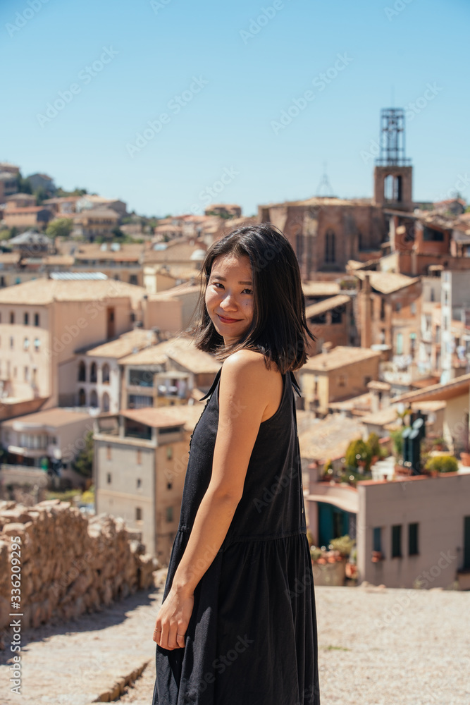 A Back Portrait of Woman at the Hill with Old European City Background A Back Portrait of Woman at the Hill with Old European City Background