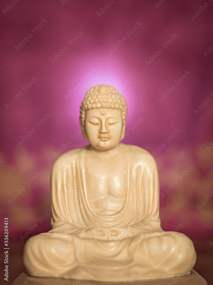 Fototapeta premium Statuette of Gautama Buddha in light marble in a prayer position