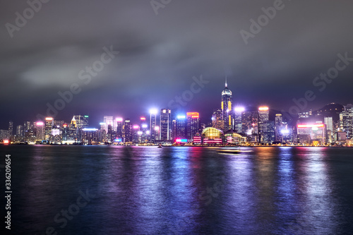 View of Victoria Harbor and Hong Kong at night. Urban landscape. © badahos