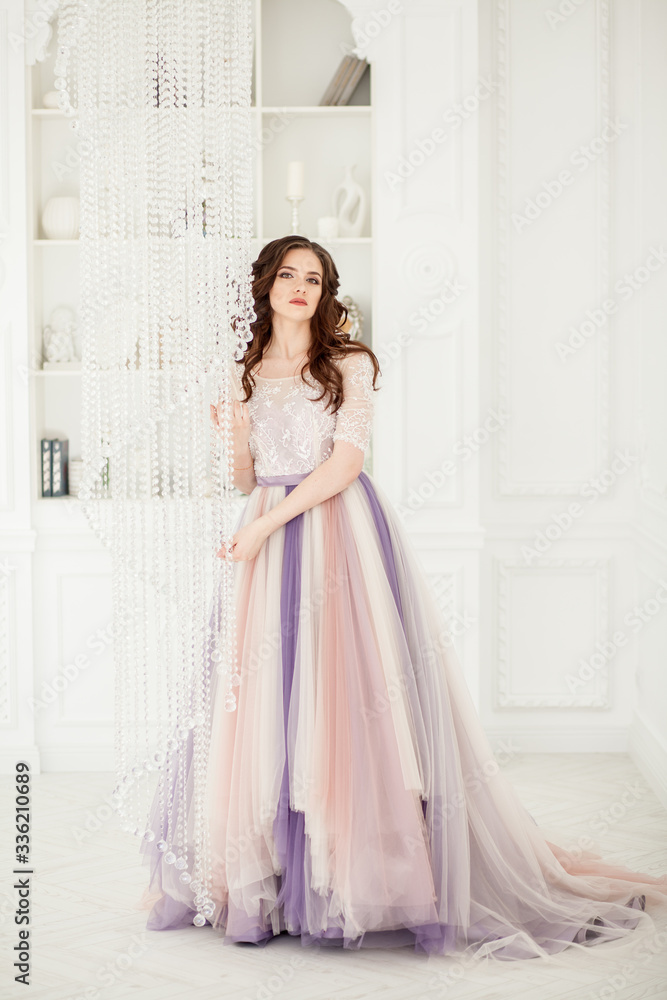 Bride in color wedding dress. Beautiful model in a beautiful wedding dress in a white photo studio. Portrait of an attractive girl in a beautiful interior. Bride in color wedding dress. Beautiful model in a beautiful wedding dress in a white photo studio. Portrait of an attractive girl in a beautiful interior.