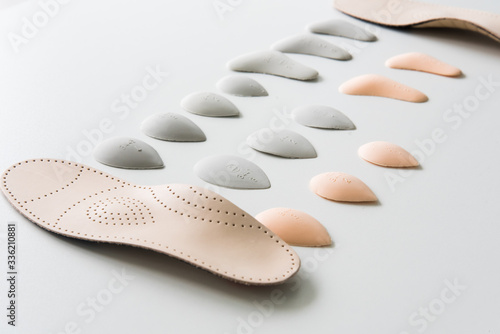 The process of manufacturing individual orthopedic insoles for people with foot diseases, flat feet. Close-up of the insole and accessories for it.