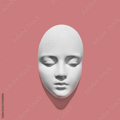 White gypsum mask of human with closed eyes