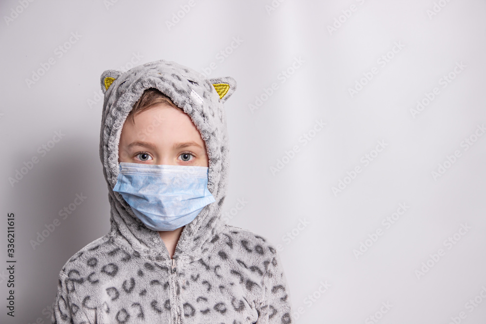 Boy in a medical mask looks forward Boy in a medical mask looks forward