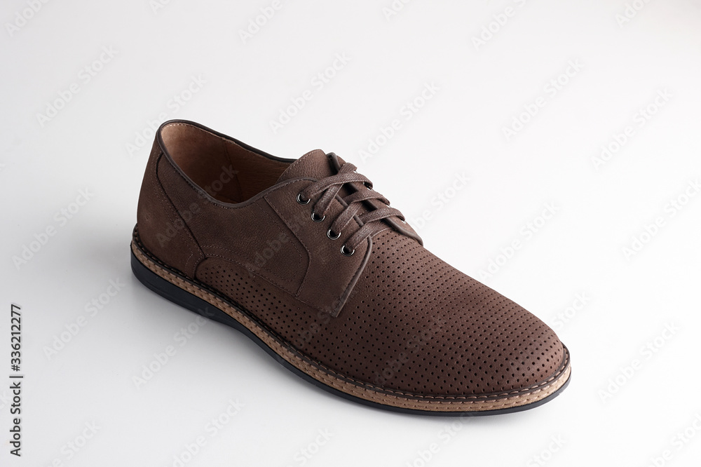 Brown men leather shoe with shoelaces on white background Brown men leather shoe with shoelaces on white background
