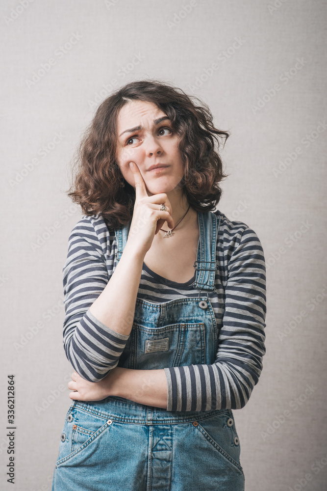 woman remembers something, dressed in overalls woman remembers something, dressed in overalls