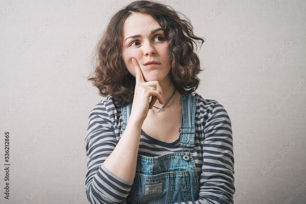 woman remembers something, dressed in overalls woman remembers something, dressed in overalls
