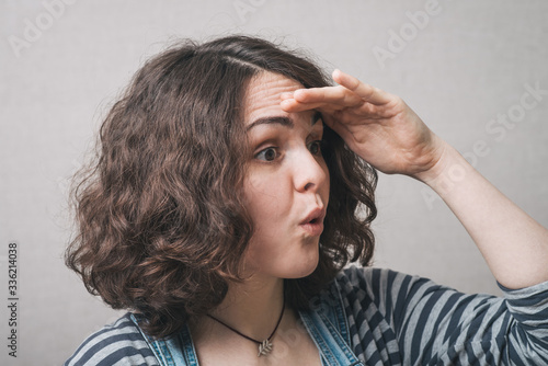 woman looking into the distance, wearing a jumpsuit