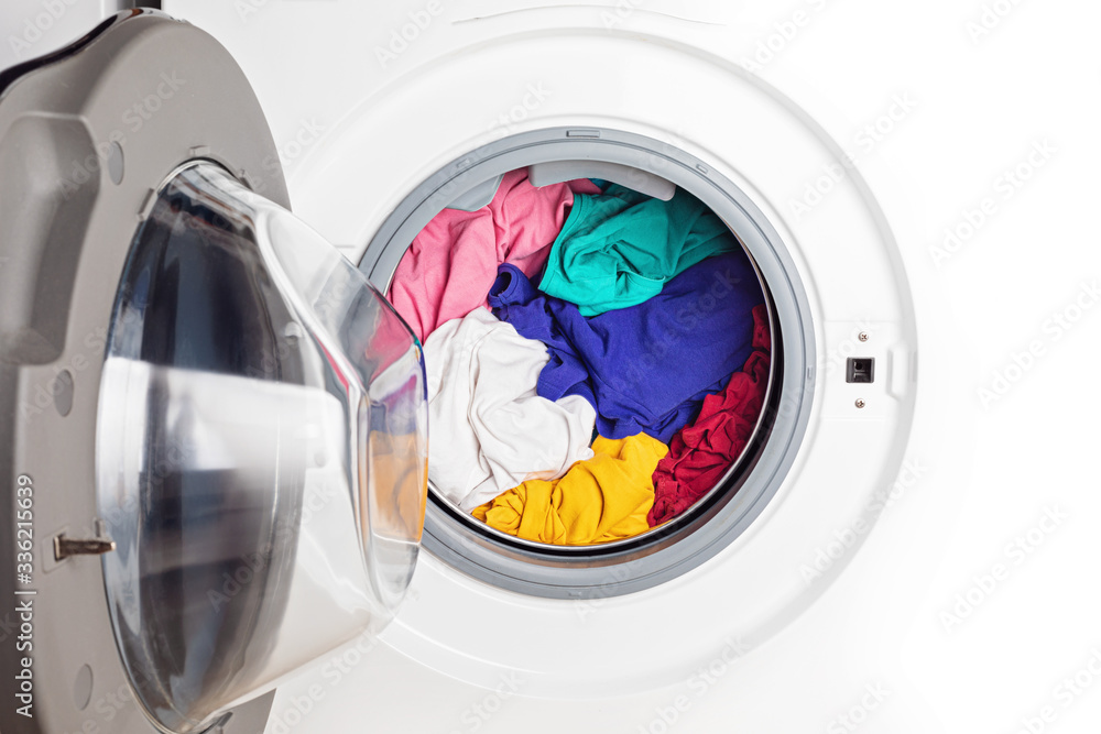 Washing or drying machine loaded with the laundry. Washing, spring cleaning idea Washing or drying machine loaded with the laundry. Washing, spring cleaning idea