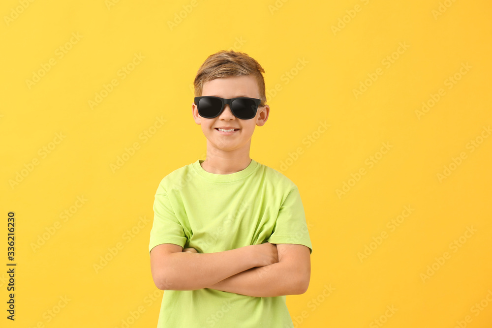 Cute little boy with sunglasses on color background Cute little boy with sunglasses on color background