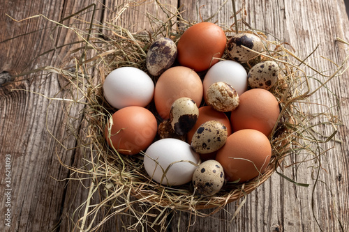 Hen and quail eggs in a basket
