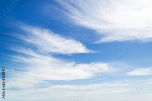Light white fluffy stratus clouds high in the blue sky on a sunny spring day. Weather and different cloud types. Scenic cloudscape. photo