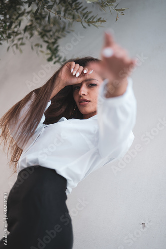 pretty brunette girl with long hair and white shirt